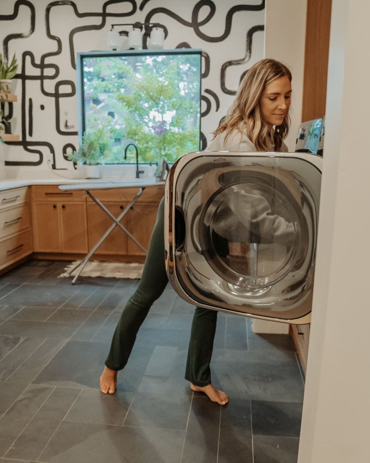 Loading the washing machine in the laundry room
