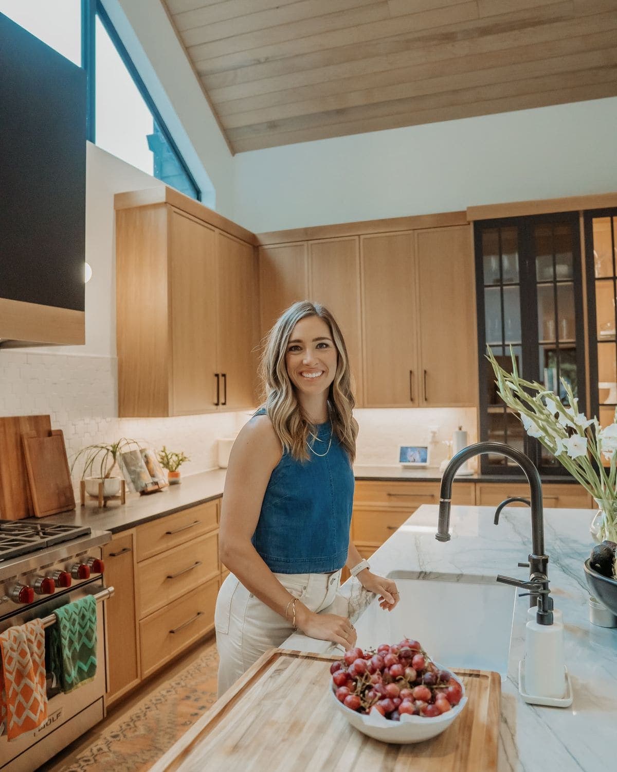 At the kitchen island beside a bowl of grapes