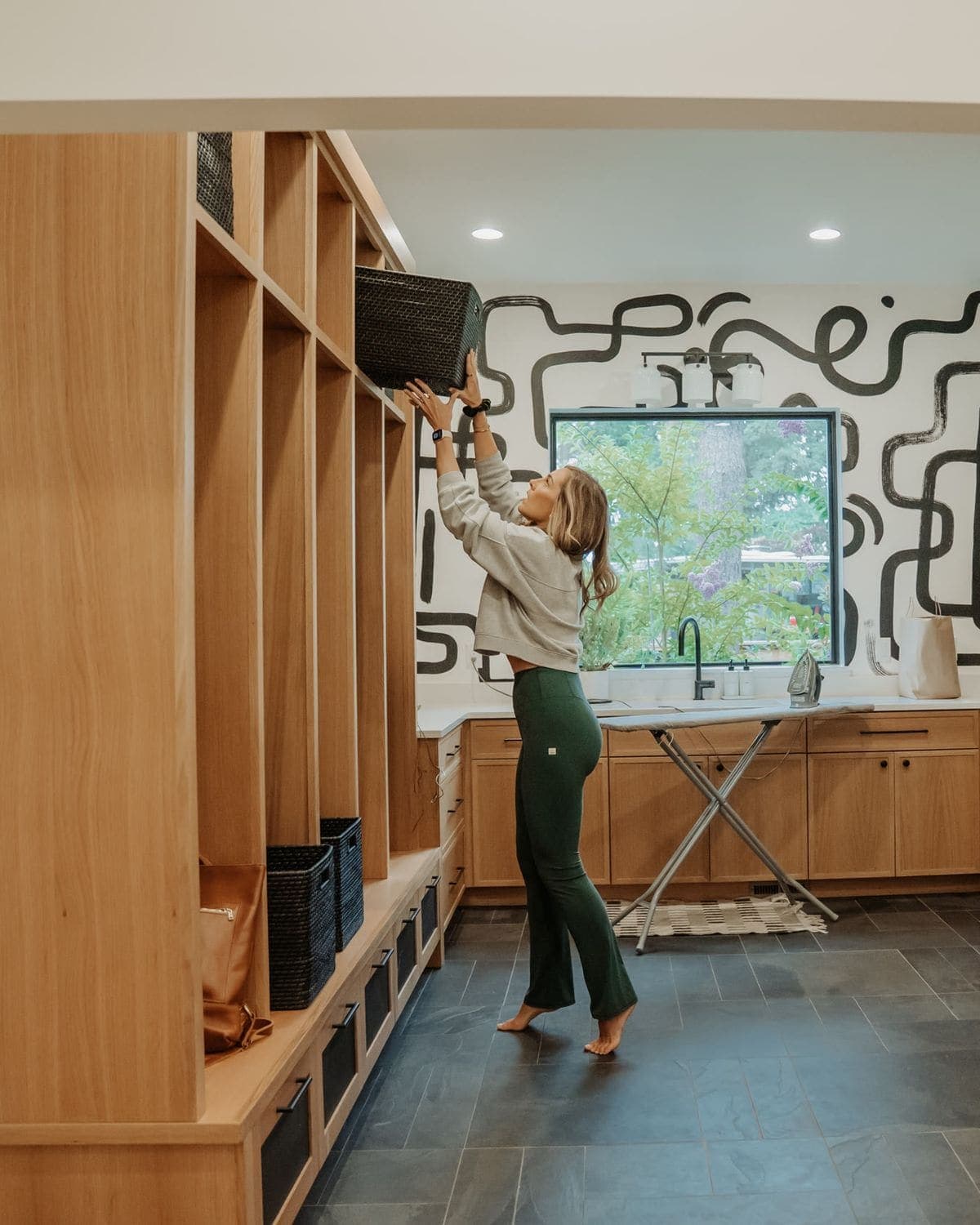 Putting baskets away in a family's mudroom