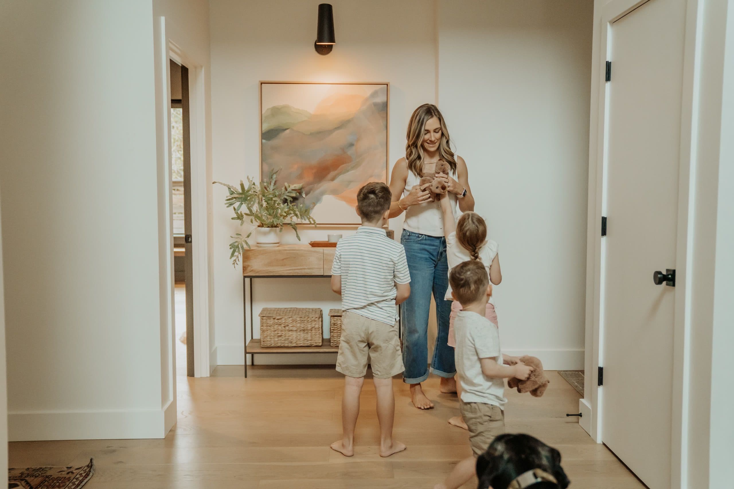 A mom and kids heading out through the entry hallway